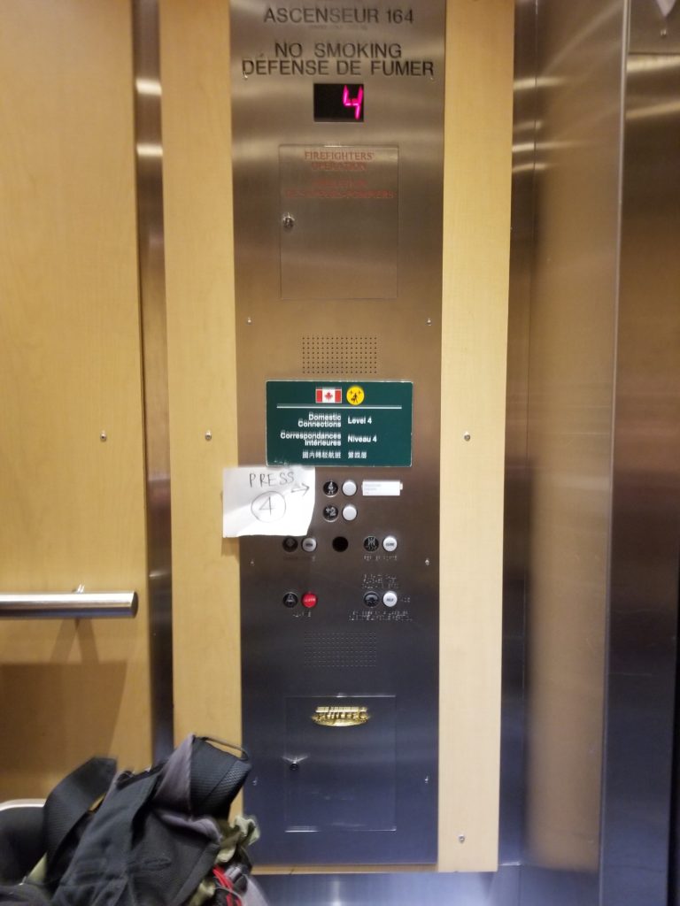 Paper taped to elevator buttons